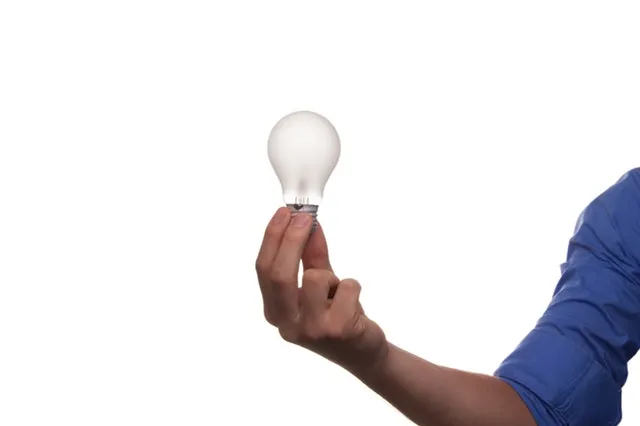 Teacher Holding Bulb