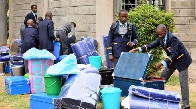 KCPE Form Ones reporting to school and undergoing checking on their personal items