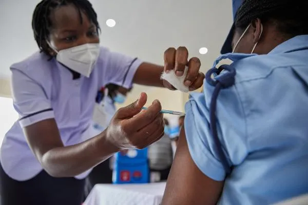 a Kenyan undergoing covid-19 vaccination